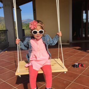 Young girl in a pink dress, jean jacket, and accessories