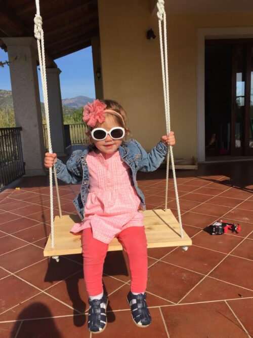 Young girl in a pink dress, jean jacket, and accessories